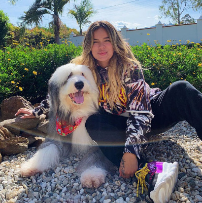 An image of Karol G and her dog