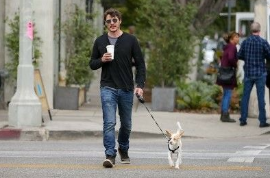 An image of Pedro Pascal and his pet dog