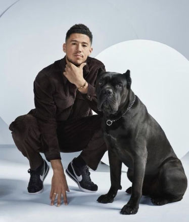 An image of Devin Booker and his Dog