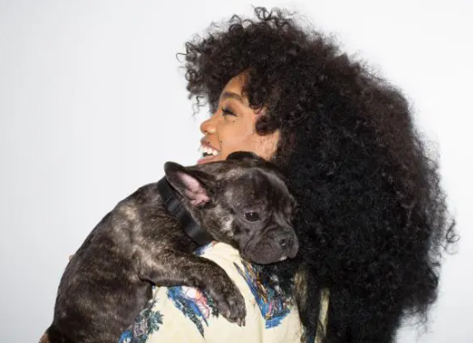 An image of Sza with her Dog