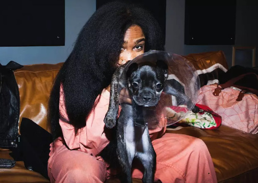 An image of Sza with her Dog