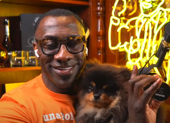 An image of Shannon Sharpe with his  dog