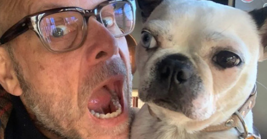 An image of Alton Brown with his  Dog